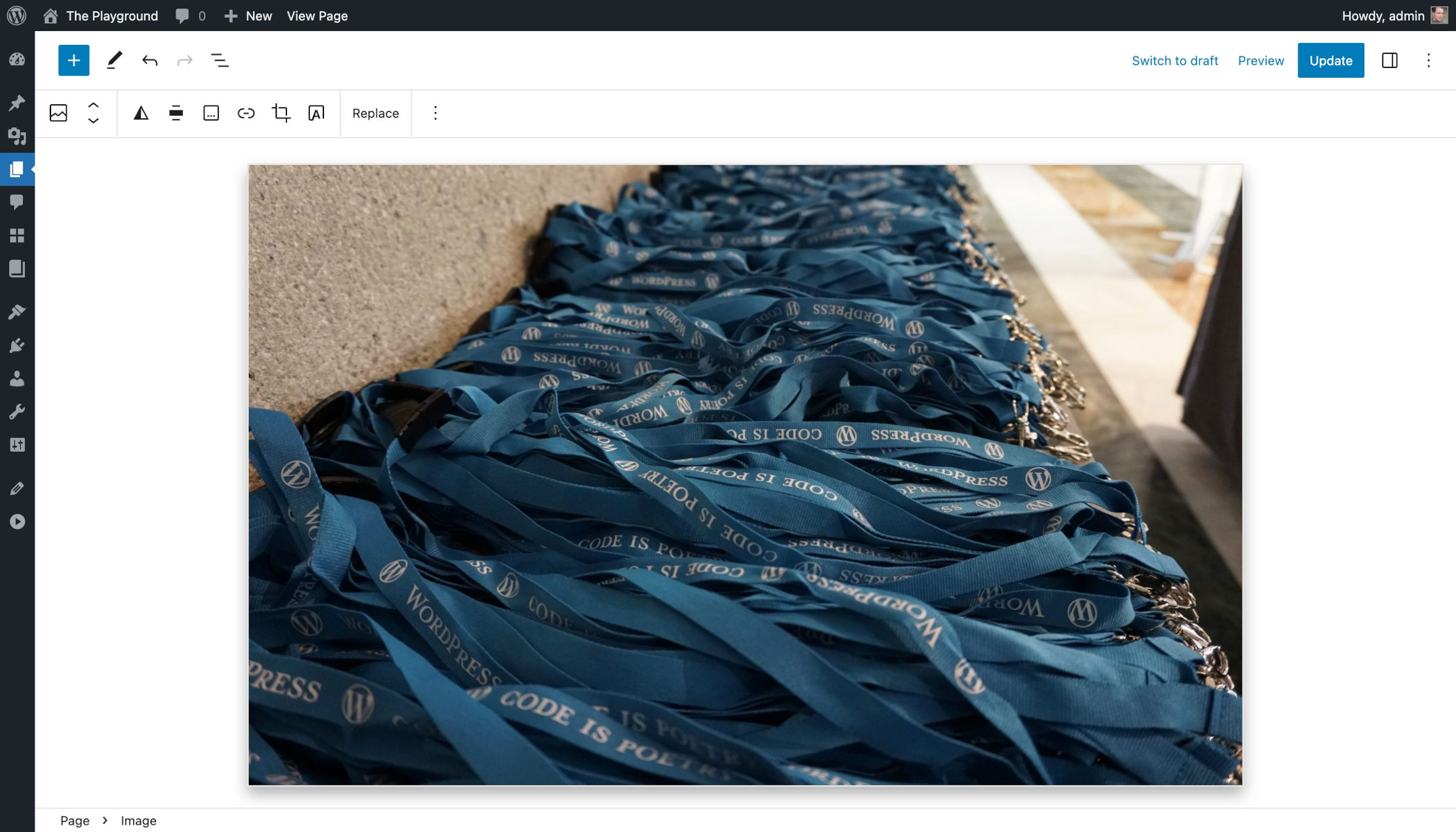 WordPress post editor with an image block that displays lanyards. The image has a large light gray shadow around it.